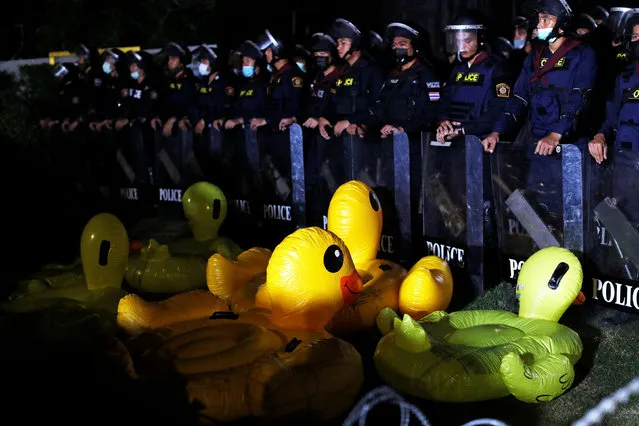 Police officers stand in front of inflatable ducks at 11th Infantry Regiment during a pro-democracy rally demanding the prime minister to resign and reforms on the monarchy, in Bangkok, Thailand, November 29, 2020. (Photo by Jorge Silva/Reuters)
