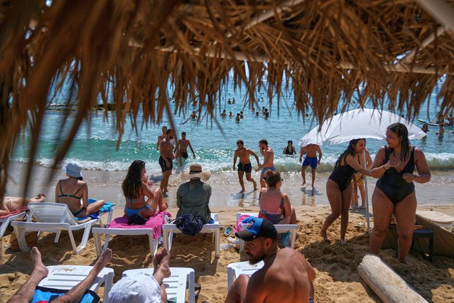 People sunbathe on a sandy beach along the Mediterranean sea in Batroun, northern Lebanon, on Saturday, May 31, 2025. (Photo by Bilal Hussein/AP Photo)