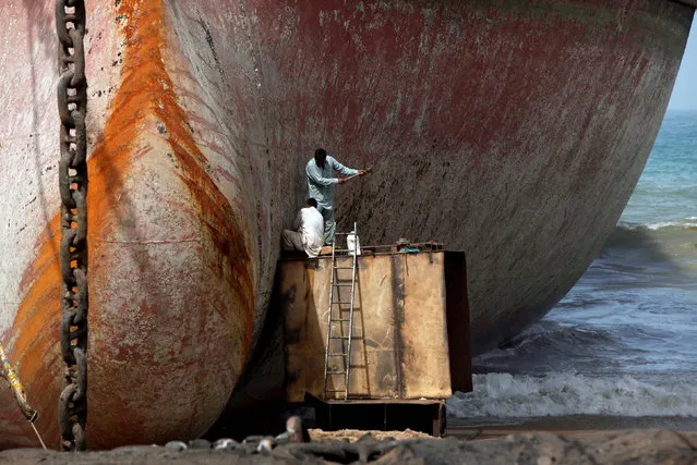 Labourers work without protective gear to separate parts of a ship for scrap metal at ship-breaking yard in Gadani, Baluchistan province Pakistan May 17, 2018. (Photo by Akhtar Soomro/Reuters)