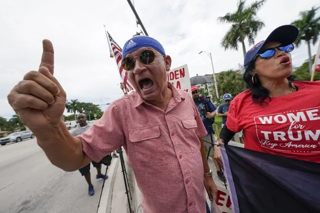 Supporters of former President Donald Trump, Oswaldo Hernandez, left, and Maribel Gonzalez of Miami, await Trump's arrival at Trump National Doral resort in Doral, Fla., Monday, June 12, 2023. (Photo by Gerald Herbert/AP Photo)