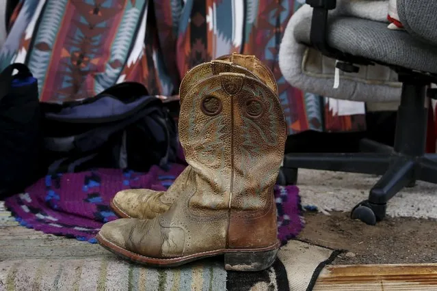 Cowboy boots, a prized possession of Richey Luper, from Newport Beach, California, are seen outside his tent at Camp Hope in Las Cruces, New Mexico October 6, 2015.. (Photo by Shannon Stapleton/Reuters)