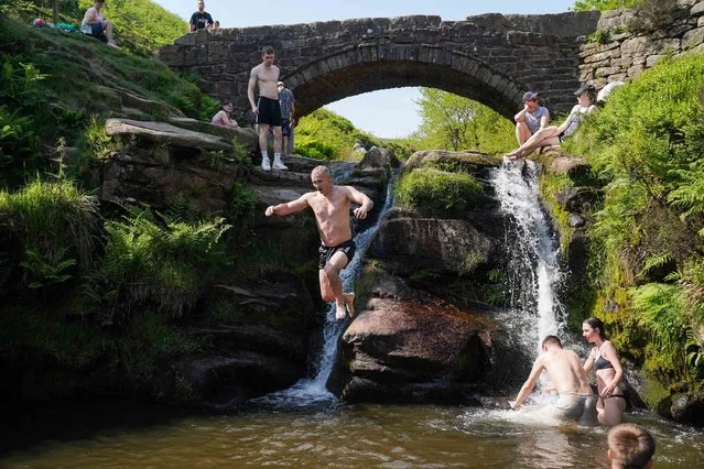 People enjoy the hot weather by Three Shires Head on the River Dane, UK where Cheshire, Derbyshire and Staffordshire meet on Saturday, June 10, 2023. (Photo by Jacob King/PA Images via Getty Images)