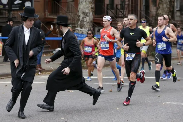 Orthodox Jewish men try to cross Bedford Avenue in the Williamsburg section of the Brooklyn borough during the 2015 New York City Marathon in New York, United States November 1, 2015. (Photo by Shannon Stapleton/Reuters)