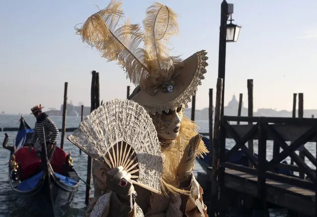 A masked reveller poses in front of Saint Mark's square during Carnival in Venice, February 8, 2015. (Photo by Stefano Rellandini/Reuters)