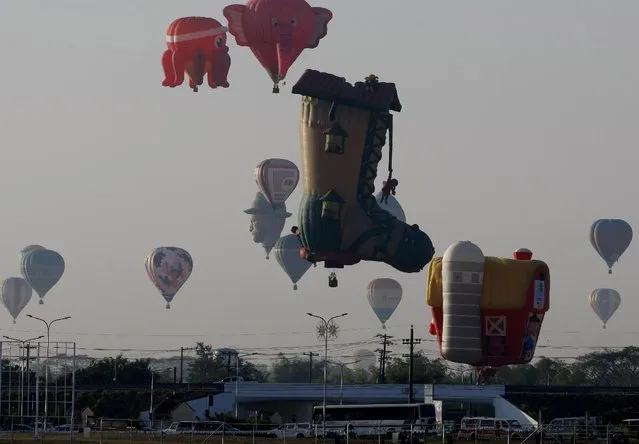 Hot air balloons dot the sky at the start of the 19th Philippine Hot Air Balloon festival Thursday, February 12, 2015 at Clark Economic Zone, Pampanga province north of Manila, Philippines. (Photo by Bullit Marquez/AP Photo)