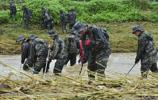 South Korean marines search for missing people in floodwaters in Yecheon, South Korea, Tuesday, July 18, 2023. Rescuers continued their searches Tuesday for people still missing in landslides and other incidents caused by more than a week of torrential rains. (Photo by Lee Moo-ryul/Newsis via AP Photo)