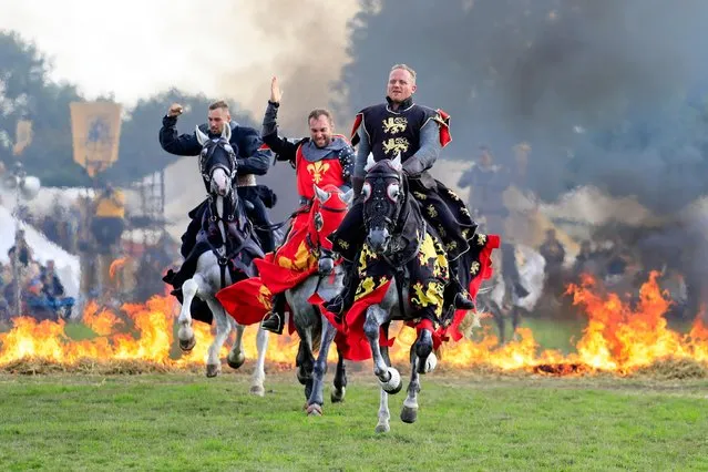 Knights on horseback ride through flames as the sun shined on todays Medieval Festival in Herstmonceux, UK on August 25, 2018.(Photo by Ed Brown/Alamy Live News)