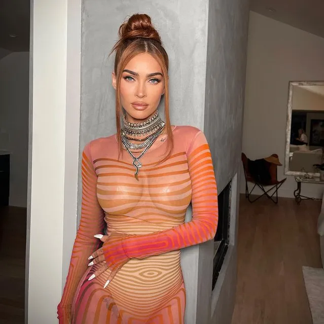 American actress Mgena Fox has shown off her curves while posing in a sheer orange in the last decade of July 2023. The Transformers actress, 36, flashed her boobs as she went braless in the skintight mesh garment.dress. (Photo by jennakristina/Instagram)