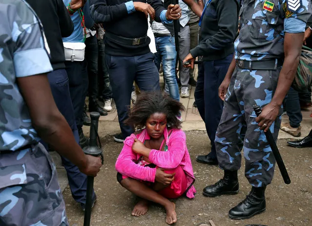 Ethiopian Federal Police officers detain a woman suspected to be carrying explosives during the welcoming ceremony of Jawar Mohammed, U.S.-based Oromo activist and leader of the Oromo Protests, in Addis Ababa, Ethiopia August 5, 2018. (Photo by Tiksa Negeri/Reuters)