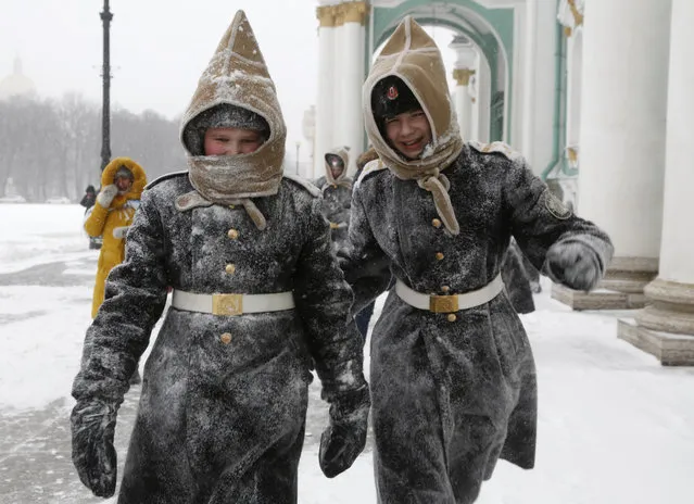 Pupils of Navy cadet classes walk in snow in St.Petersburg, Russia, Tuesday, January 12, 2016. Low temperatures caused the two-days of snowfall in St.Petersburg. (Photo by Dmitry Lovetsky/AP Photo)