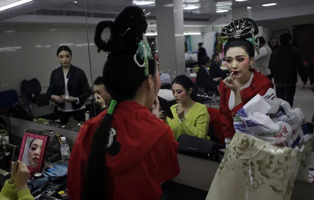 Chinese artists from Anhui Hungmei Opera theatre apply makeup backstage before performing "Goddess Marriage" opera in New Delhi, India, Thursday, January 14, 2016. "Goddess Marriage" is a love story between immortal and mortal which was organized by China National Tourism Administration to kick-start 2016 as a year for "China-India Tourism". (Photo by Altaf Qadri/AP Photo)