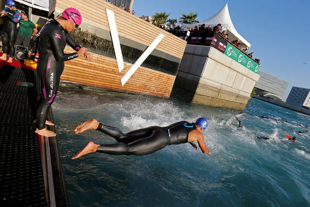 Participants jump in the water to swim during the Ironman 70.3 Middle East Championship Bahrain triathlon, in Manama, Bahrain, December 10, 2016. (Photo by Hamad I Mohammed/Reuters)