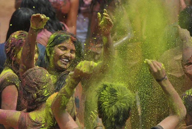 Indian revellers dance as during Holi celebrations in Hyderabad on March 5, 2015. Holi, also called the Festival of Colours, is a popular Hindu spring festival observed in India at the end of the winter season on the last full moon day of the lunar month. AFP PHOTO / Noah SEELAM        (Photo credit should read NOAH SEELAM/AFP/Getty Images)