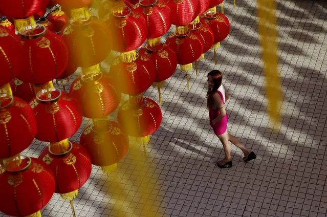 A woman walks under chinese lanterns ahead of Chinese New Year celebrations on February 8 at a temple in Kuala Lumpur, Malaysia, February 1, 2016. (Photo by Olivia Harris/Reuters)