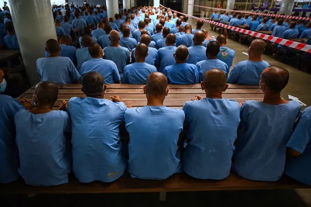 Inmates wait 30 minutes in case they experience side effects after receiving doses of the Sinopharm Covid-19 coronavirus vaccine at Chonburi Central Prison on June 25, 2021. (Photo by Lillian Suwanrumpha/AFP Photo)