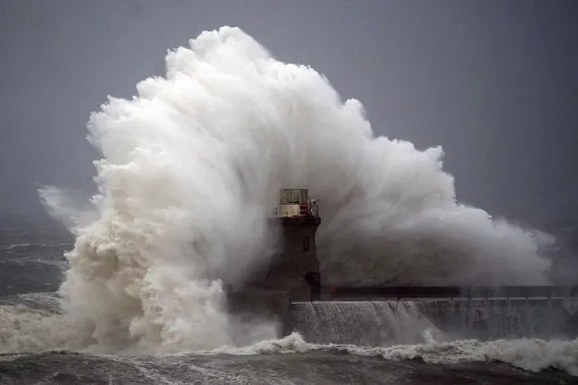 Waves crash against a lighthouse after the top was ripped off, in South Shields, northeastern England, Friday, October 20, 2023.  Authorities across northern Europe urged vigilance Friday as the region braced for heavy rain and gale-force winds from the east as a severe storm continued to sweep through. (Photo by Owen Humphreys/PA Wire via AP Photo)