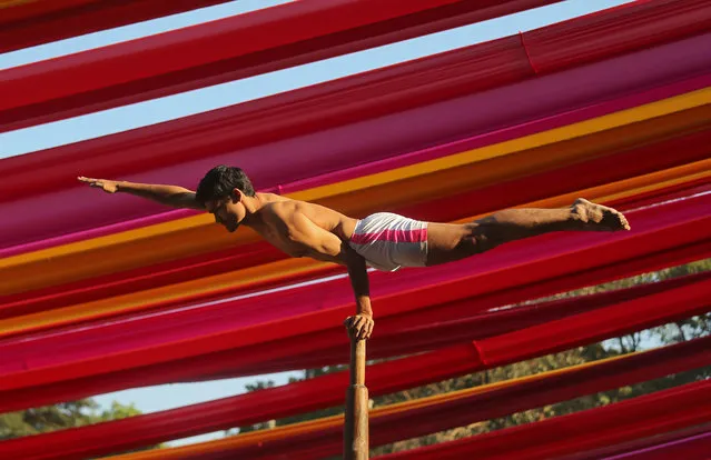 A man performs “Malkhamb” (traditional Indian gymnastics) during a college festival in Mumbai, India, December 27, 2018. (Photo by Francis Mascarenhas/Reuters)