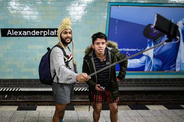 People wearing no pants take a selfie as they participate in the worldwide event “No Pants Subway Ride” in Berlin, Germany, January 13, 2019. (Photo by Clemens Bilan/EPA/EFE/Rex Features/Shutterstock)