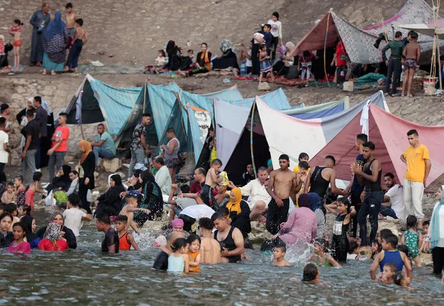 People enjoy in the water of the Nile river during hot weather in the Qanater outskirts of Cairo, Egypt, 06 August 2021. (Photo by Khaled Elfiqi/EPA/EFE)