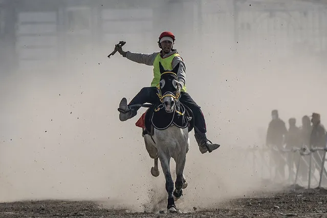 An Afghan rider competes during the first 2023 Fall Horse Racing tournament at the Chaman-e-Huzuri field in Kabul on December 7, 2023. (Photo by Wakil Kohsar/AFP Photo)