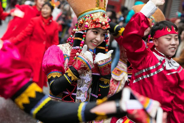 Women at the Chinese New Year parade display traditional costume in London, UK on February 10, 2019. More than 50 groups participate in the procession around the streets of central London to celebrate the Year of the Pig. The pig is believed to be a symbol of optimism, enthusiasm and hard/working. The celebration, the event biggest outside Asia, attracts thousands of people each year. (Photo by Jonny Weeks/The Guardian)