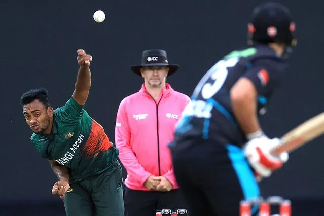 Bangladesh's Shoriful Islam (L) bowls to New Zealand's Daryl Mitchell (R) during the first Twenty20 cricket match between New Zealand and Bangladesh at McLean Park in Napier on December 27, 2023. (Photo by Marty Melville/AFP Photo)