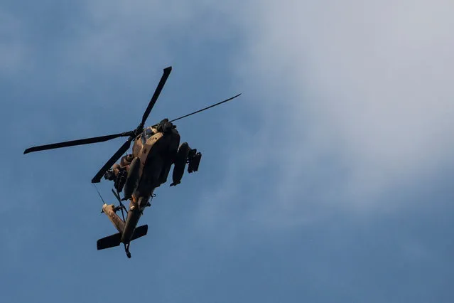 An Israeli Apache helicopter is seen in the skies over Israel's border with Lebanon, in northern Israel on October 9, 2023. (Photo by Ammar Awad/Reuters)