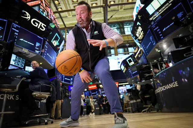 Trader Matt Macgregor dribbles a Wilson basketball on the trading floor during the Amer Sports, (AS.N) sporting goods brands, IPO at the New York Stock Exchange (NYSE) in New York City, U.S., February 1, 2024. (Photo by Brendan McDermid/Reuters)