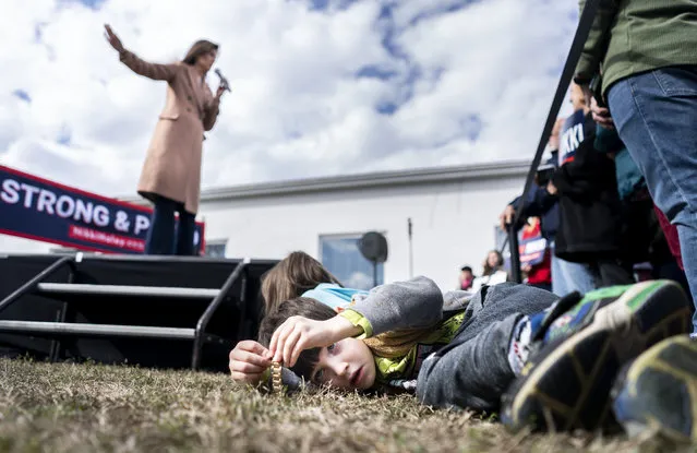 A little boy plays in the grass during a rally where Republican Presidential candidate Nikki Haley speaks to South Carolina voters at the American Legion Post 15 in Sumter, South Carolina on Monday February 19, 2024. (Melina Mara/The Washington Post)