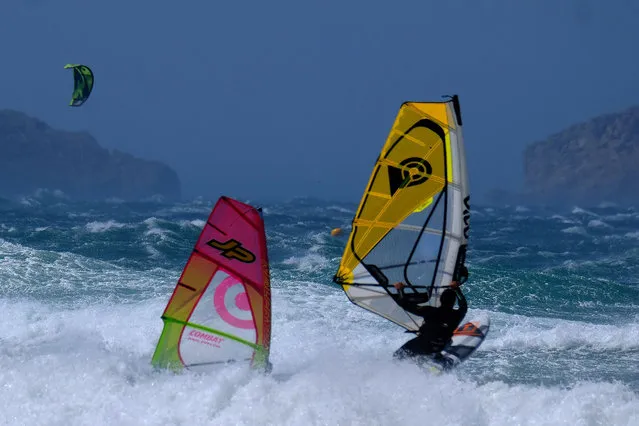 People practise windsurf in heavy waves as strong wind blows at the Plage du David beach in downtown Marseille, as storm Eleanor hits southern parts of France on May 5, 2019. (Photo by Boris Horvat/AFP Photo)