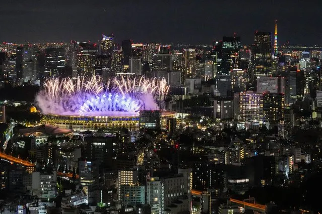 Fireworks illuminates over National Stadium during the opening ceremony of 2020 Tokyo Olympics, Friday, July 23, 2021, in Tokyo. (Photo by Kiichiro Sato/AP Photo)