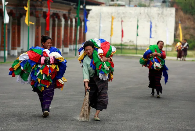 Women carry flags in Tashichho Dzong, the seat of the head of Bhutan's Civil Government in Thimphu in preparation for the visit of Britain's Prince William and his wife Catherine, the Duchess of Cambridge, Bhutan, April 13, 2016. (Photo by Cathal McNaughton/Reuters)