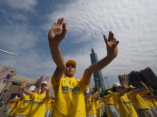 Taiwan Falun Gong members meditate to protest against China's persecution beside the Taipei 101 in Taipei, Taiwan, 24 April 2016. Falun Gong, founded by Li Hongzhi in China, combines meditation and study of Li's teachings and promotes Truthfullness, Compassion and Tolerance. China banned Falun Gong as an illegal sect in 1999. Since then, China has jailed many Falun Gong practitioners and harvested organs of some Falun Gong members for human organ translant, leaving at least 3,900 Falun Gong members dead, according to Taiwan Falun Gong. (Photo by David Chang/EPA)
