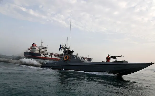 A speedboat of the Iran's Revolutionary Guard moves around a British-flagged oil tanker Stena Impero, which was seized on Friday by the Guard, in the Iranian port of Bandar Abbas, Sunday, July 21, 2019. Iranian officials say the seizure of the British oil tanker was a justified response to Britain's role in impounding an Iranian supertanker two weeks earlier off the coast of Gibraltar, a British territory located on the southern tip of Spain. (Photo by Hasan Shirvani/Mizan News Agency via AP Photo)