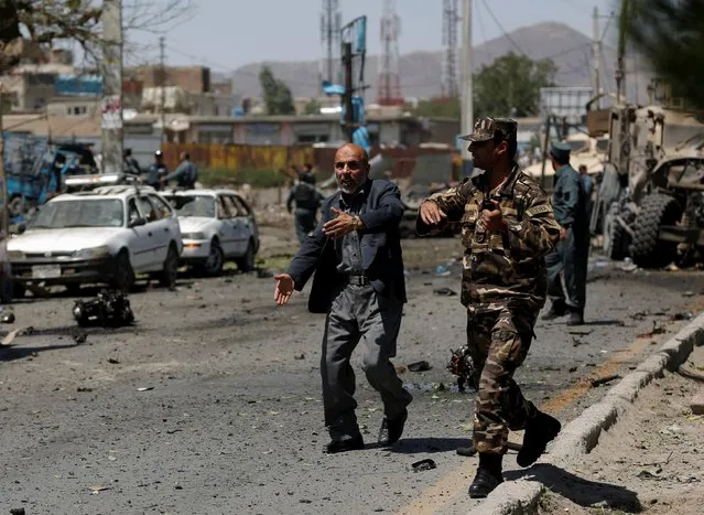 Afghan security personnel react at the site of a suicide bomb attack in Kabul, Afghanistan June 30, 2015. (Photo by Ahmad Masood/Reuters)