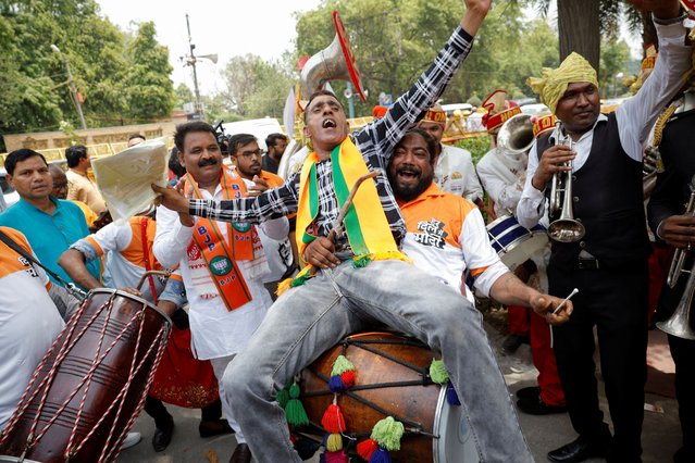 Bharatiya Janata Party (BJP) supporters celebrate after learning the initial general election results outside party headquarters in New Delhi, India, on June 4, 2024. (Photo by Adnan Abidi/Reuters)