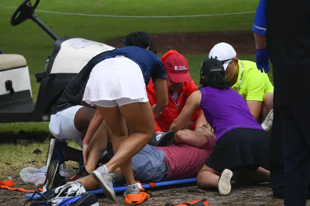 A spectators is tended to after a lightning strike on the course which left several injured during a weather delay in the third round of the Tour Championship golf tournament Saturday, August 24, 2019, in Atlanta. (Photo by John Amis/AP Photo)