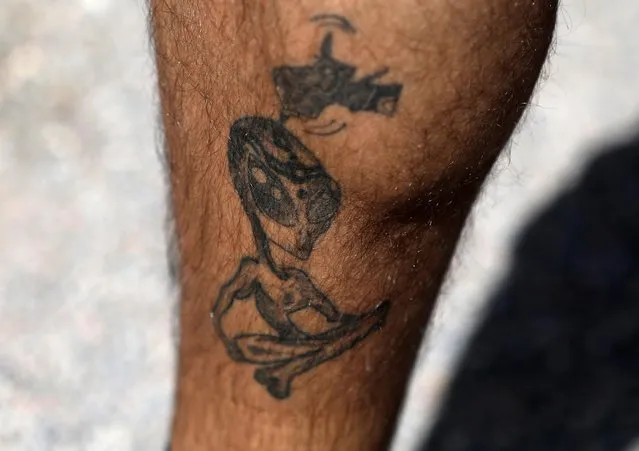 An attendee shows an alien-themed tattoo in Rachel, Nevada on September 19, 2019. In June, California college student Matty Roberts posted a facetious Facebook invitation exhorting the public at large to run into Area 51 on foot to “see them aliens”. When more than 1 million people expressed interest, the U.S. Air Force admonished curiosity seekers not to breach the gates at the military base, which it said is still used to test combat aircraft and train personnel. (Photo by Jim Urquhart/Reuters)