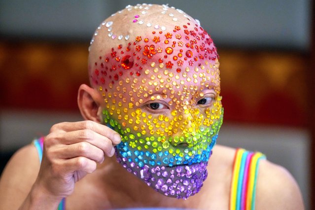 An LGBTQ participant decorate his face before a news conference in Bangkok, Thailand , Monday, May 20, 2024. (Photo by Sakchai Lalit/AP Photo)