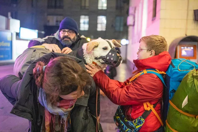 Ukrainians carry their dog near the Kyiv-Pasazhyrskyi railway station in Kyiv, Ukraine, Thursday, February 24, 2022. Russia has launched a full-scale invasion of Ukraine, unleashing airstrikes on cities and military bases. (Photo by Oleksandr Khomenko/UPI/Rex Features/Shutterstock)