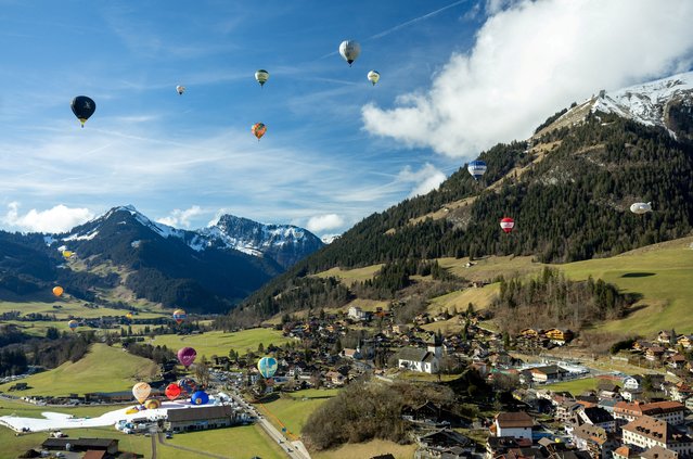 Balloons take part in the 44th International Hot Air Balloon Festival in Chateau-d'Oex, Switzerland on January 25, 2024. (Photo by Denis Balibouse/Reuters)