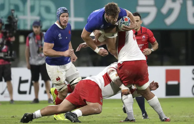 France's Damian Penaud is tackled by Tongan defenders during the Rugby World Cup Pool C game at Kumamoto Stadium between France and Tonga in Kumamoto, Japan, Sunday, October 6, 2019. (Photo by Aaron Favila/AP Photo)