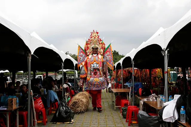 A participant dressed in a traditional costume walks during a rehearsal of a performance for the inauguration ceremony of President-elect Tsai Ing-wen, in Taipei, Taiwan May 18, 2016. (Photo by Tyrone Siu/Reuters)