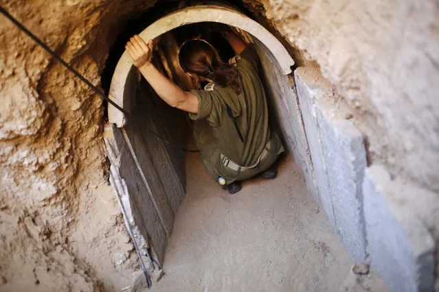 An Israeli soldier squats in a tunnel exposed by the Israeli military near Kibbutz Ein Hashlosha, just outside the southern Gaza Strip October 13, 2013. (Photo by Amir Cohen/Reuters)