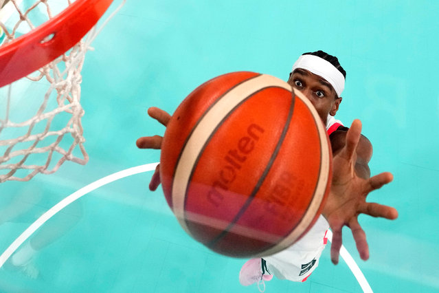 Canada's Shai Gilgeous-Alexander grabs a rebound during a men's basketball game aa; at the 2024 Summer Olympics, Tuesday, July 30, 2024, in Villeneuve-d'Ascq, France. (Photo by Michael Conroy/AP Photo)