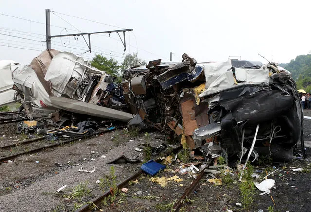 The wreckage of a passenger train is pictured after it crashed into the back of a freight train in the eastern Belgian municipality of Saint-Georges-Sur-Meuse, June 6, 2016. (Photo by Francois Lenoir/Reuters)