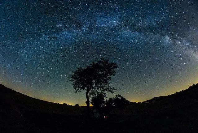 A photo made available 21 July 2015 of the glowing band of the so-called “Milky Way” seen in the summer night sky over the vicinity of Salgotarjan, 109 kilometers northeast of Budapest, Hungary, late 20 July 2015. The “Milky Way” is the galaxy that contains our own Solar system and appears as a disc shape bright band in the sky, although it can rarely been seen by the naked eye. (Photo by Peter Komka/EPA)