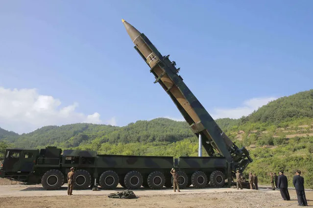 In this photo distributed by the North Korean government,  North Korean leader Kim Jong Un, second from right, inspects the preparation of the launch of a Hwasong-14 intercontinental ballistic missile, ICBM, in North Korea's northwest Tuesday, July 4, 2017. Independent journalists were not given access to cover the event depicted in this photo. North Korea claimed to have tested its first intercontinental ballistic missile in a launch Tuesday, a potential game-changing development in its push to militarily challenge Washington – but a declaration that conflicts with earlier South Korean and U.S. assessments that it had an intermediate range. (Photo by Korean Central News Agency/Korea News Service via AP Photo)
