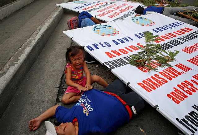 A girl cries beside her mother acting as a mock earthquake casualty during a metrowide earthquake drill along main highway EDSA in Makati, Metro Manila, Philippines June 22, 2016. (Photo by Erik De Castro/Reuters)