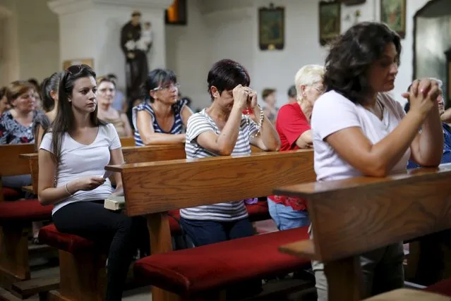 Women pray for Tomislav Salopek in local church in Vrpolje village, Croatia, August 12, 2015. An Egyptian group allied to Islamic State has published a photograph it says showed the beheaded body of a Croatian hostage it threatened to kill last week, the SITE monitoring service said on Wednesday. (Photo by Antonio Bronic/Reuters)